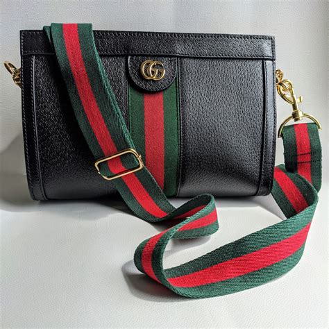 gucci handbag with guitar strap.